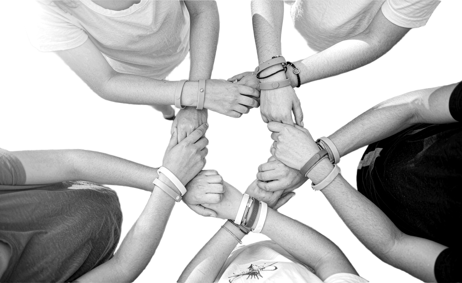 Group stacking wrists wearing custom wristbands — monochrome photo on white